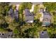 An aerial shot of the residence with its well-manicured lawn, privacy fence and surrounding foliage at 1000 Chesterfield Cir, Winter Springs, FL 32708