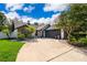 Charming single-Gathering home featuring a well-manicured lawn, mature trees, and a spacious driveway at 1000 Chesterfield Cir, Winter Springs, FL 32708