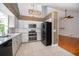 Modern kitchen featuring white cabinets, stainless steel appliances, and tile floors at 1000 Chesterfield Cir, Winter Springs, FL 32708