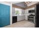 Well-equipped kitchen with white cabinetry, stainless steel appliances, and a stylish blue door at 1000 Chesterfield Cir, Winter Springs, FL 32708