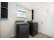 Modern laundry room equipped with full size washer and dryer and utility cabinets at 1000 Chesterfield Cir, Winter Springs, FL 32708