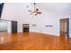 Living room featuring a stone fireplace, hardwood floors, and a ceiling fan at 1000 Chesterfield Cir, Winter Springs, FL 32708