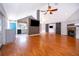 Open living room featuring a fireplace, barn door, and hardwood floors, with access to the kitchen at 1000 Chesterfield Cir, Winter Springs, FL 32708
