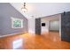 Bright living room with hardwood floors, sliding barn door, and a large window at 1000 Chesterfield Cir, Winter Springs, FL 32708