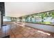 Relaxing sunroom featuring a tiled floor, screened windows, and views of the lush backyard at 1000 Chesterfield Cir, Winter Springs, FL 32708