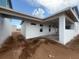 Backyard view of a modern home showcasing the outdoor patio and lush green space at 10224 Fiddley Aly, Orlando, FL 32827