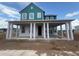 Charming two-story home with blue siding, white trim, and a covered front porch at 10224 Fiddley Aly, Orlando, FL 32827