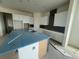 Modern kitchen with white cabinets, a large island, and stylish gray backsplash at 10224 Fiddley Aly, Orlando, FL 32827