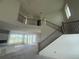Bright and airy living room with a grand staircase and large windows offering scenic views at 10224 Fiddley Aly, Orlando, FL 32827