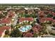 Overhead view showcasing community pool surrounded by palms and red-tile roofs at 12106 Poppy Field Ln # 107, Orlando, FL 32837
