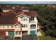Aerial view of the community reveals well-maintained townhomes with private garages and vibrant landscaping at 12106 Poppy Field Ln # 107, Orlando, FL 32837