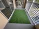 Enjoy the outdoor space on this screened balcony featuring artificial turf for a cozy and low-maintenance setting at 12106 Poppy Field Ln # 107, Orlando, FL 32837