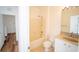 Bright bathroom with a shower and tub combination, a white toilet, and a vanity sink with a gold faucet at 12106 Poppy Field Ln # 107, Orlando, FL 32837
