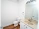 Neat half bathroom featuring white cabinets and a clean, modern design, vanity, toilet, and mirror at 12106 Poppy Field Ln # 107, Orlando, FL 32837