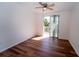 Bright bedroom featuring wood floors, a ceiling fan, and a sliding door to the balcony for seamless indoor-outdoor living at 12106 Poppy Field Ln # 107, Orlando, FL 32837