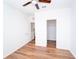 Bedroom featuring hardwood floors, a ceiling fan, and closet access at 12106 Poppy Field Ln # 107, Orlando, FL 32837