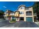 Inviting townhouse complex with well-maintained grounds, garages, and charming exterior details at 12106 Poppy Field Ln # 107, Orlando, FL 32837