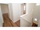 Second floor hallway featuring hardwood floors and access to rooms at 12106 Poppy Field Ln # 107, Orlando, FL 32837