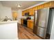 A spacious kitchen with stainless steel appliances, wooden cabinets, and eat-in space at 12106 Poppy Field Ln # 107, Orlando, FL 32837