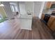 Open kitchen and living area with wood floors, bar seating, and plenty of natural light at 12106 Poppy Field Ln # 107, Orlando, FL 32837