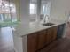 Open-concept kitchen island with stainless steel sink and breakfast bar at 12106 Poppy Field Ln # 107, Orlando, FL 32837