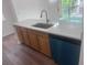 Kitchen island featuring stainless steel sink, updated countertop, and blue dishwasher at 12106 Poppy Field Ln # 107, Orlando, FL 32837
