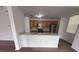 Bright kitchen with light wood cabinets, stainless steel appliances, and a breakfast bar at 12106 Poppy Field Ln # 107, Orlando, FL 32837