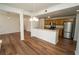 Open-concept kitchen and living area with wood cabinets, stainless steel appliances, and hardwood floors at 12106 Poppy Field Ln # 107, Orlando, FL 32837