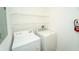 Clean laundry room featuring new washer and dryer and storage shelves at 12106 Poppy Field Ln # 107, Orlando, FL 32837