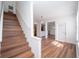 Open-concept living space with hardwood floors, staircase, and a kitchen visible in the background at 12106 Poppy Field Ln # 107, Orlando, FL 32837
