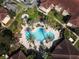Aerial shot of a unique cloverleaf pool design surrounded by landscaping at 12106 Poppy Field Ln # 107, Orlando, FL 32837