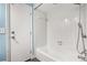 Bathroom with a white tiled shower and tub combo with a door to hallway at 126 Duncan Trl, Longwood, FL 32779
