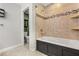Bathroom featuring bath and shower combo with decorative tile and adjacent toilet at 126 Duncan Trl, Longwood, FL 32779
