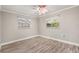 Bedroom with updated flooring, ceiling fan, and natural light from windows at 126 Duncan Trl, Longwood, FL 32779