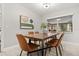 Bright dining room with modern table set, stylish artwork, and view to backyard at 126 Duncan Trl, Longwood, FL 32779