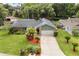 Charming single-Gathering home featuring a well-manicured lawn, mature landscaping, and an attached two-car garage at 126 Duncan Trl, Longwood, FL 32779