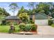 Charming single-story home with brick accents, lush landscaping, and an attached two-car garage at 126 Duncan Trl, Longwood, FL 32779