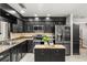 Modern kitchen with black cabinetry, stainless steel appliances, granite countertops, and ample lighting at 126 Duncan Trl, Longwood, FL 32779