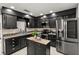 Modern kitchen with black cabinetry, stainless steel appliances, granite countertops, and ample lighting at 126 Duncan Trl, Longwood, FL 32779
