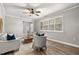 Bright living room with hardwood floors, plantation shutters, and neutral-colored furniture at 126 Duncan Trl, Longwood, FL 32779