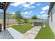 Landscaped backyard with synthetic grass, a stone paver path, and an outdoor hot tub at 13227 Spring Grove Way, Winter Garden, FL 34787