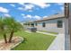Green backyard featuring synthetic turf, palm trees, and an outdoor hot tub at 13227 Spring Grove Way, Winter Garden, FL 34787