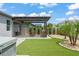 Landscaped backyard featuring a pergola with bar, patio, artificial turf, and palm trees at 13227 Spring Grove Way, Winter Garden, FL 34787