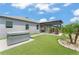 Green backyard featuring a spa, a pergola-covered outdoor kitchen, and manicured tropical landscaping at 13227 Spring Grove Way, Winter Garden, FL 34787