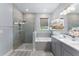 Elegant bathroom with glass shower, soaking tub, double sink vanity, and contemporary finishes at 13227 Spring Grove Way, Winter Garden, FL 34787