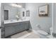 Bathroom with double sinks, gray cabinetry, large mirror and modern fixtures at 13227 Spring Grove Way, Winter Garden, FL 34787