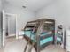 bedroom featuring wooden bunk beds, neutral decor and light hardwood floors at 13227 Spring Grove Way, Winter Garden, FL 34787
