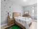 Sports themed bedroom with matching decor including bedspread, wall decals, and a green sports rug at 13227 Spring Grove Way, Winter Garden, FL 34787