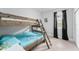 Cozy bedroom featuring wooden bunk beds, light hardwood floors, and black out curtains at 13227 Spring Grove Way, Winter Garden, FL 34787