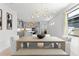 Dining room with view of kitchen, pendant lighting and modern furnishings at 13227 Spring Grove Way, Winter Garden, FL 34787